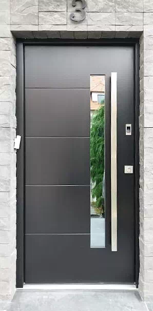 Widok elewacji domu z zamontowanymi drzwiami wzór 417,12 wymalowanymi w kolorze antracytowe.